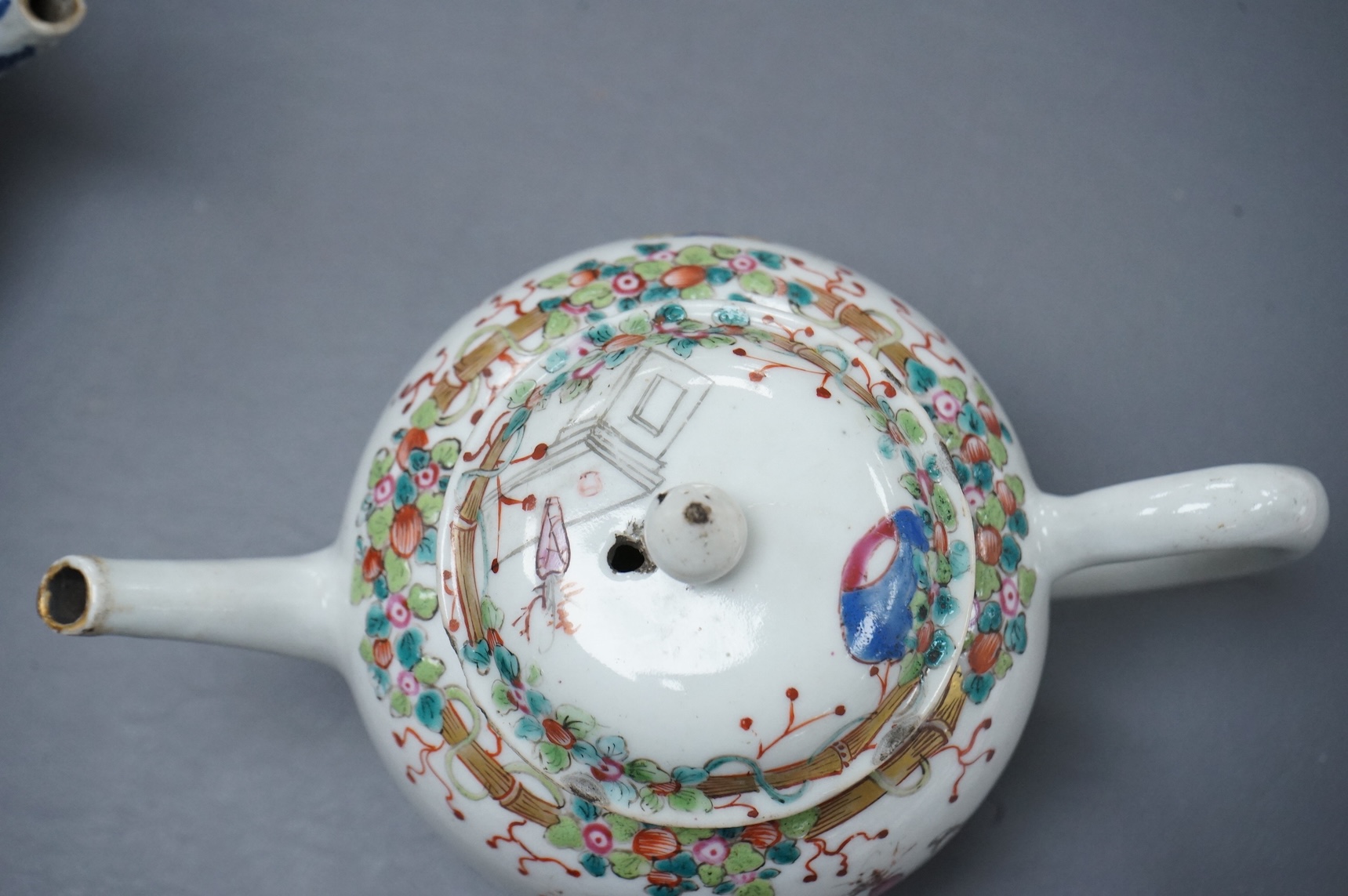 A Chinese famille rose ‘boys and ladies’ teapot, Qianlong period and a Japanese Arita sake pot or ewer, early 18th century, tallest 16cm high.